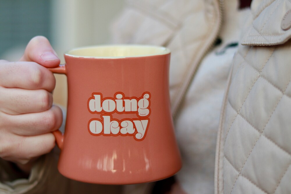 orange mug with the words doing okay